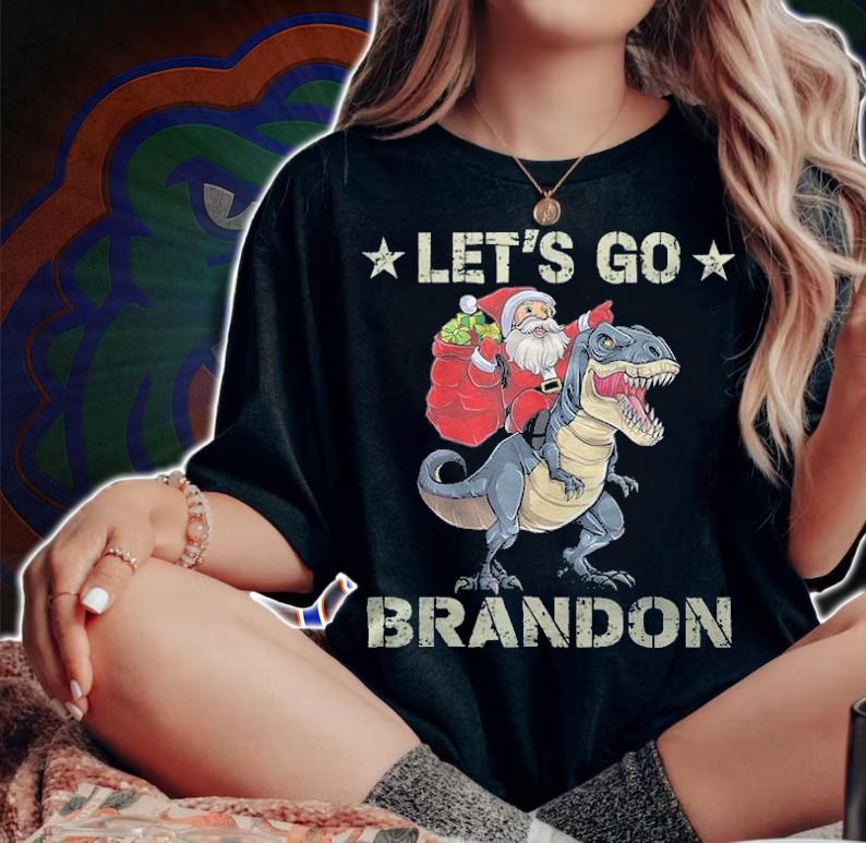 Premium let's Go Brandon American Flag Impeach Biden Santa Claus Ridding Dinosaur T-Shirt t-shirt